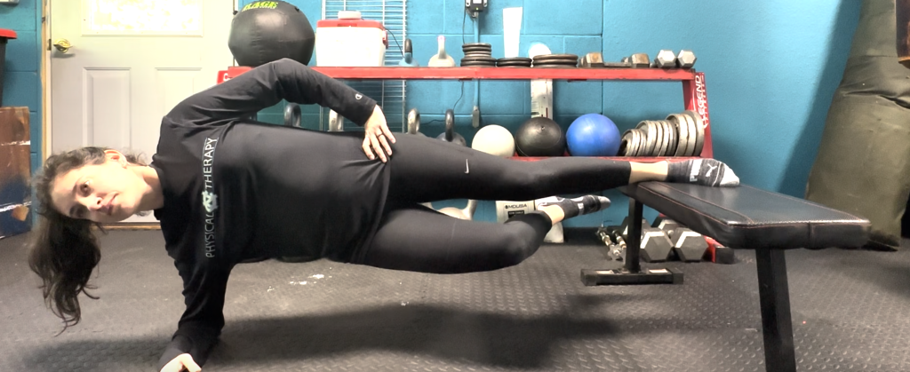 physical therapist working one-on-one with an athlete during a movement assessment